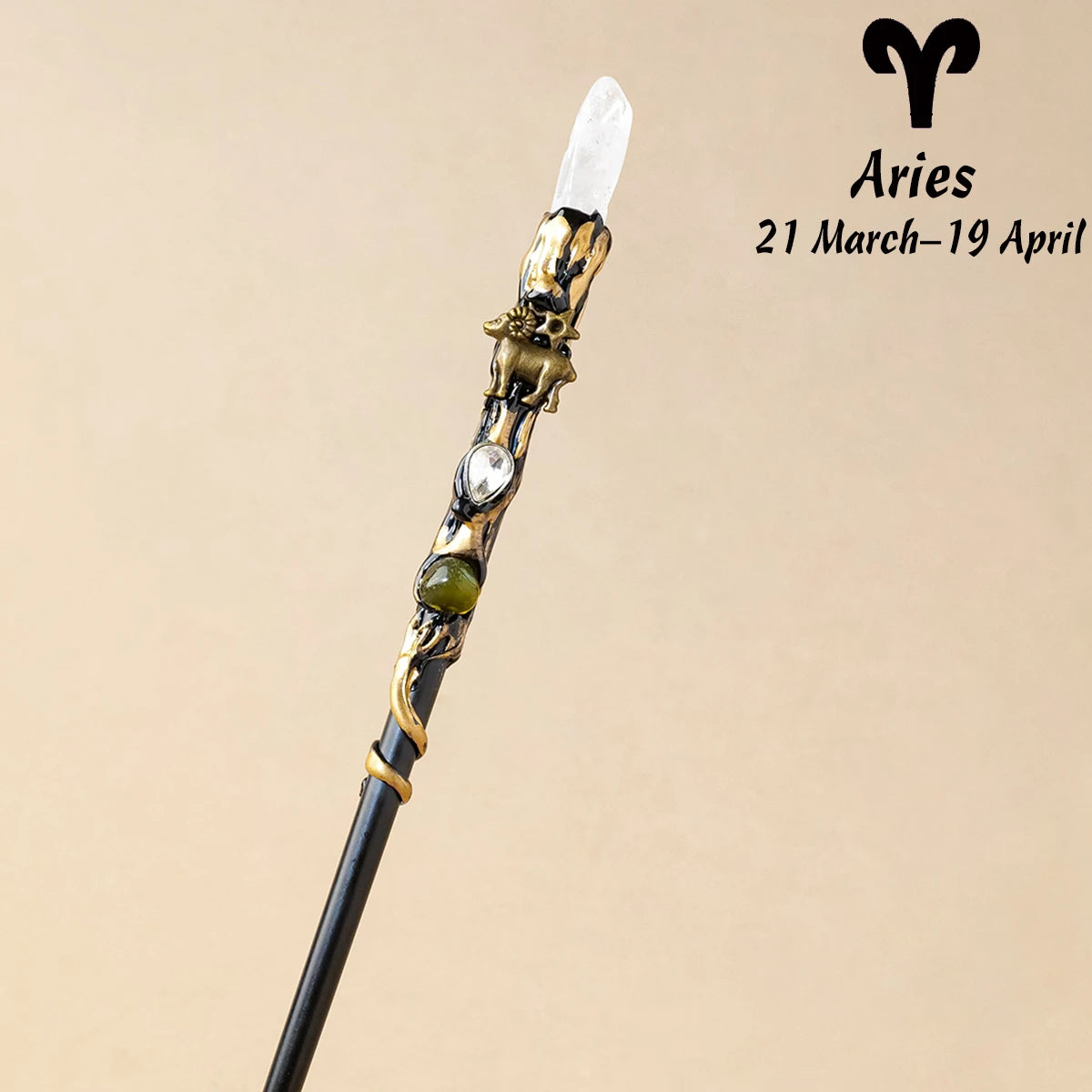 A natural clear quartz zodiac crystal wand with gold accents, representing Aries.