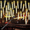 Halloween LED floating candles suspended by wires, with a magic wand illuminating them in a church setting.