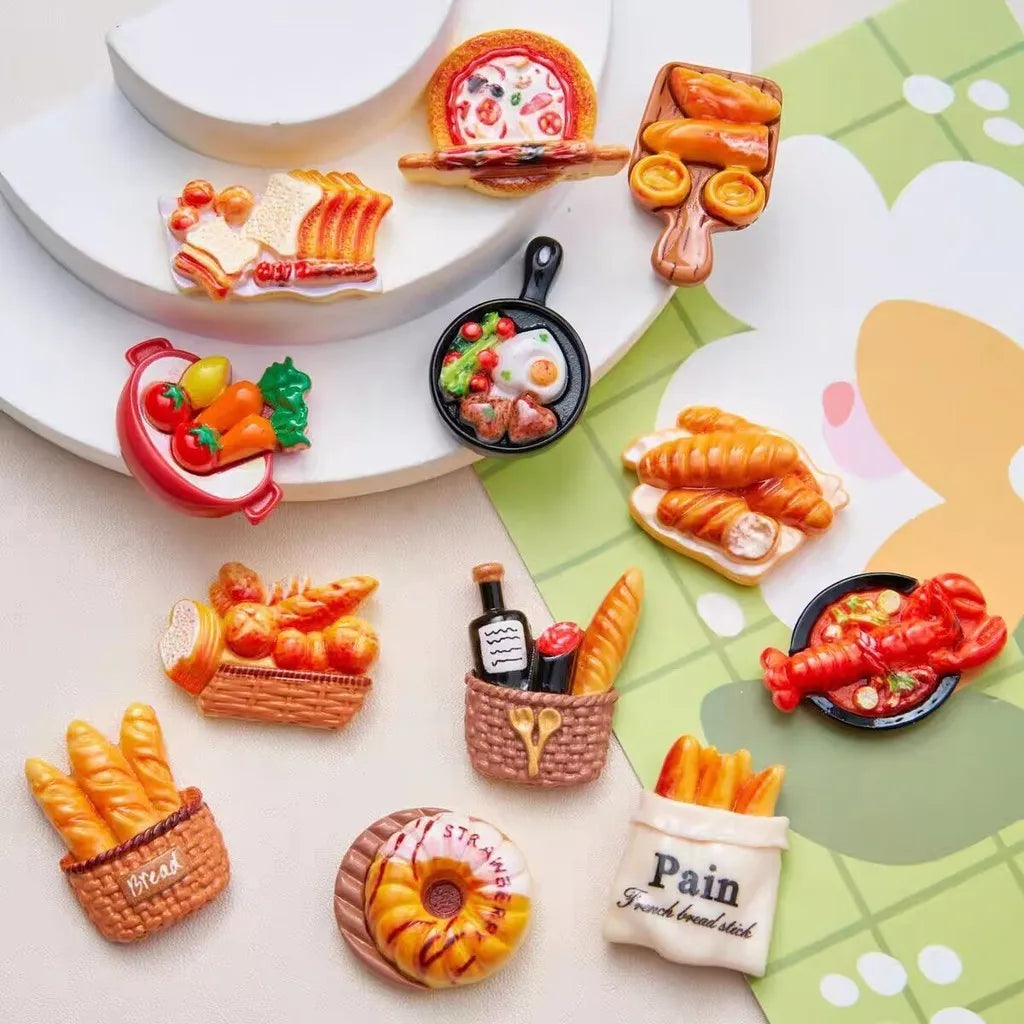 Un set de aimants de réfrigérateur en fausse nourriture, représentant des croissants, des bâtons de pain et un donut.