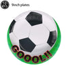 A soccer ball cake topper featuring a white and black patterned ball with red text that reads GOOOL!