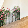 A wooden fence wall decal featuring pink roses and green foliage on a white background.