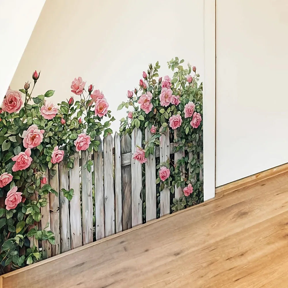A wooden fence wall decal featuring pink roses and green foliage on a white background.