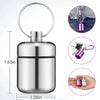 Silver mini waterproof pill organizer keychain with a pink and silver color scheme