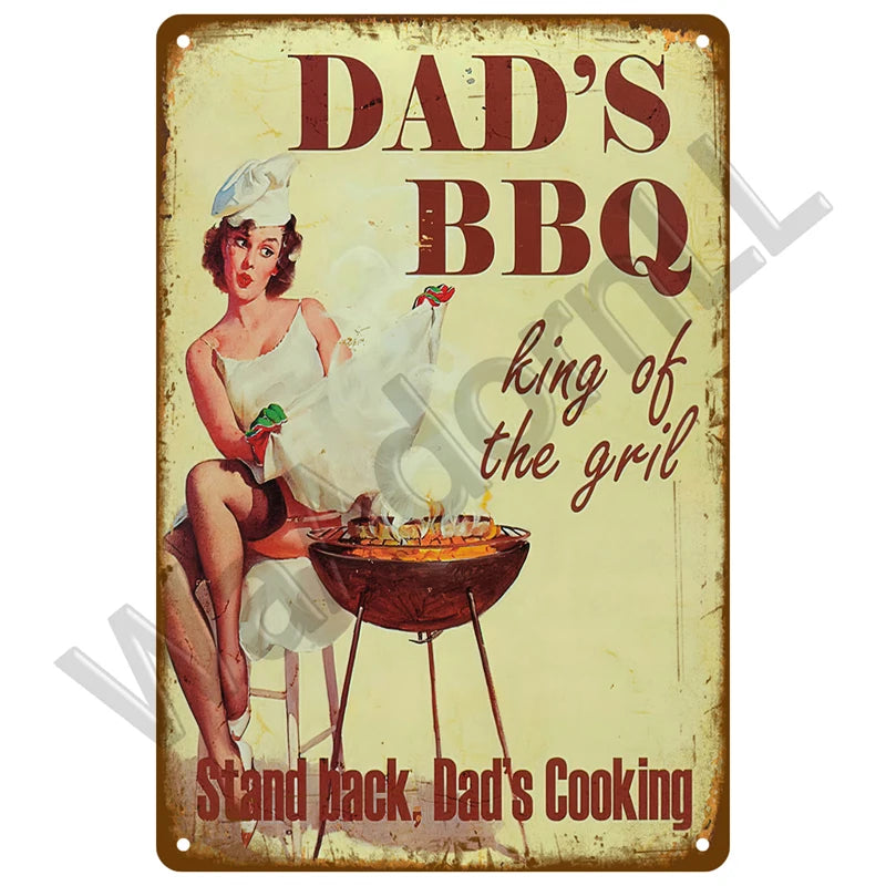 A vintage metal sign featuring a woman cooking BBQ, with text that reads Dad's BBQ king of the grill and Stand back Dad's Coo