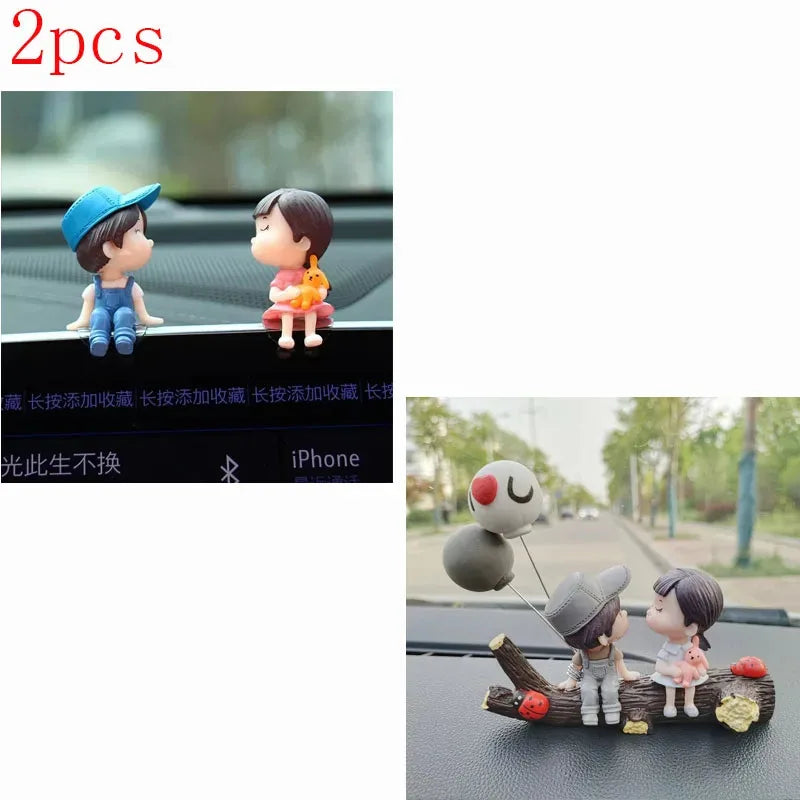 A set of two cute couple balloon car ornaments featuring a boy and a girl.