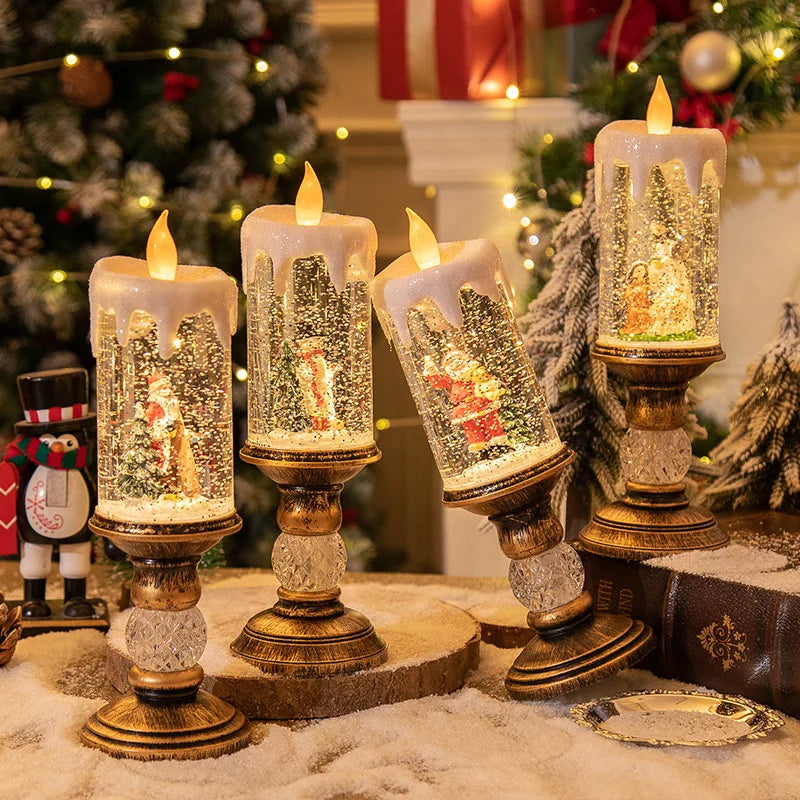 A festive snowflake candle wind lamp displayed on a golden candlestick with sparkling glass and festive greenery.