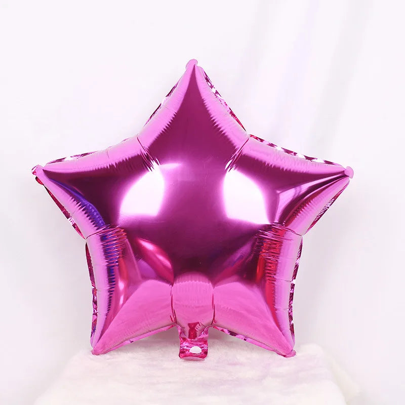 Un ballon en feuille brillant en forme d'étoile magenta.