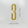 A polished gold house number shaped like the numeral three with a self-adhesive backing.