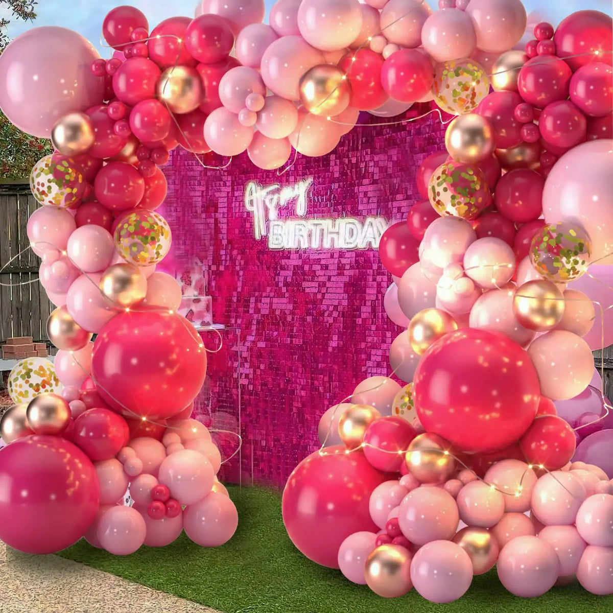A pink and gold balloon garland arch kit featuring numerous balloons for celebrations.
