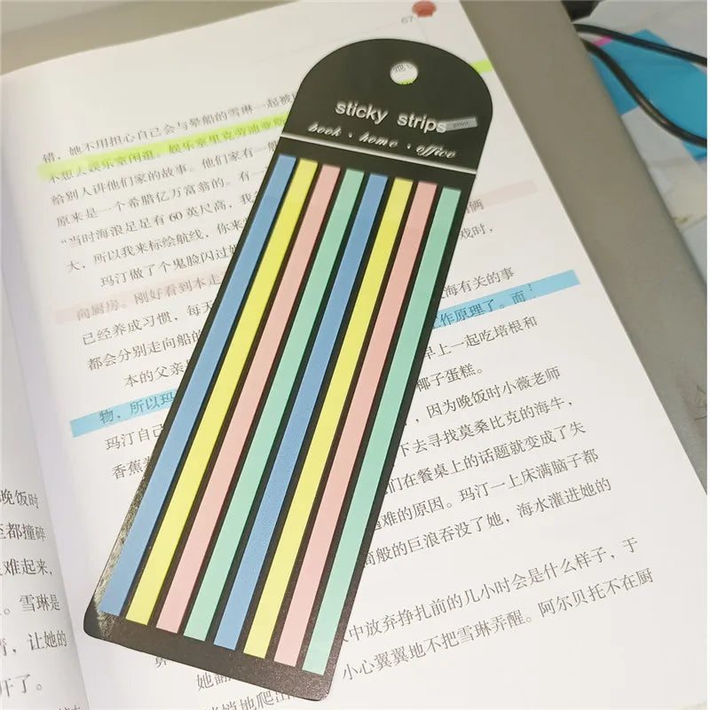 A set of sticky strips with various colored stripes used as book or office index tabs.