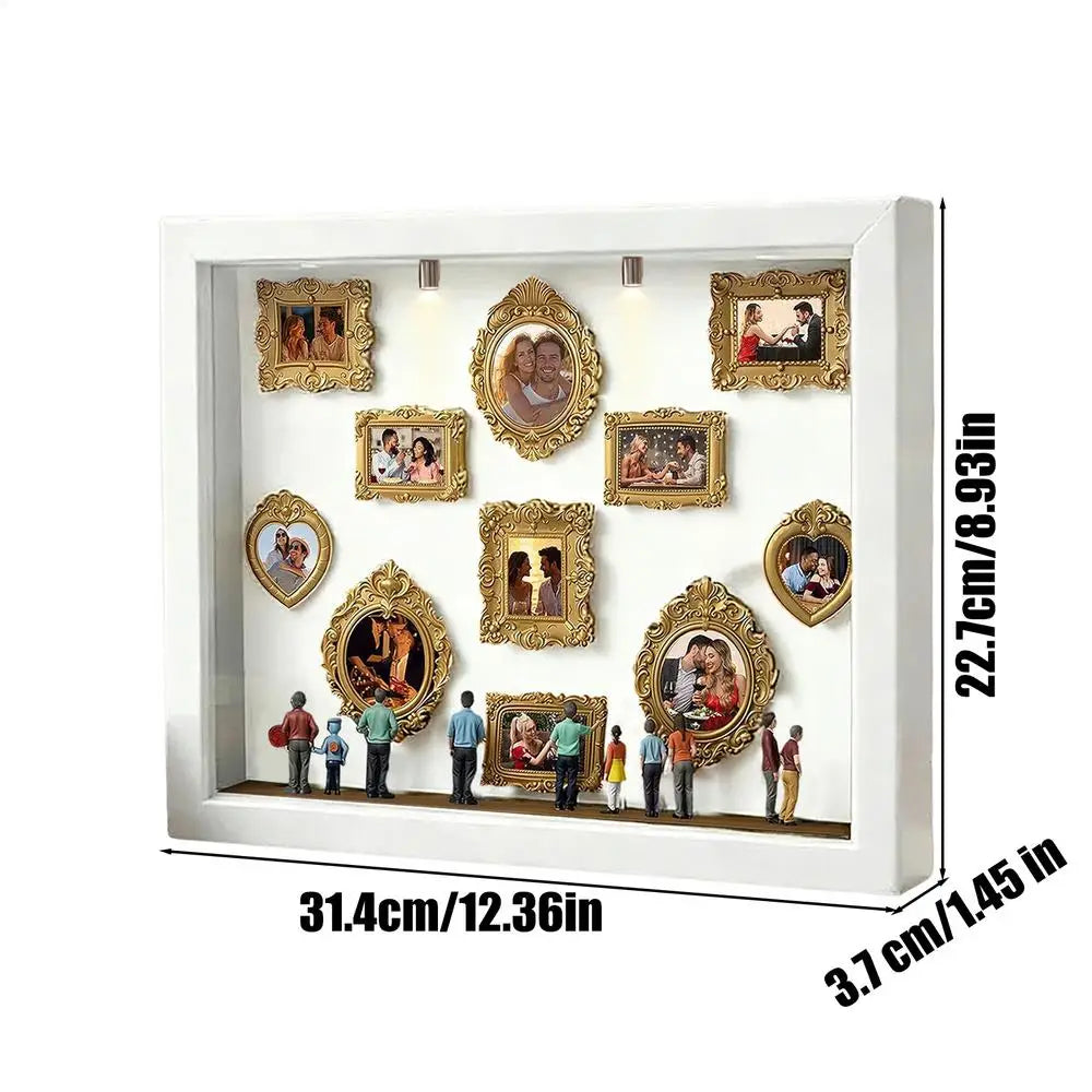 A white framed display featuring several oval and rectangular photo frames with gold accents.