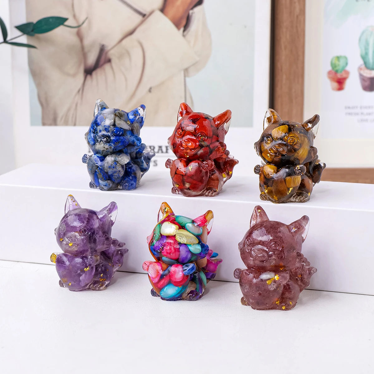 A collection of natural fox crystal sculptures in various colors and textures displayed on a white surface.