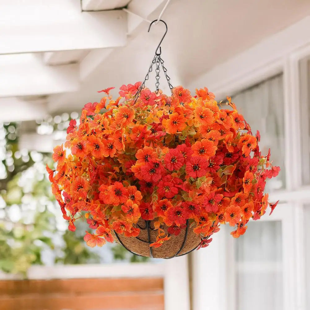 A vibrant orange artificial flower hanging basket suspended from the ceiling.