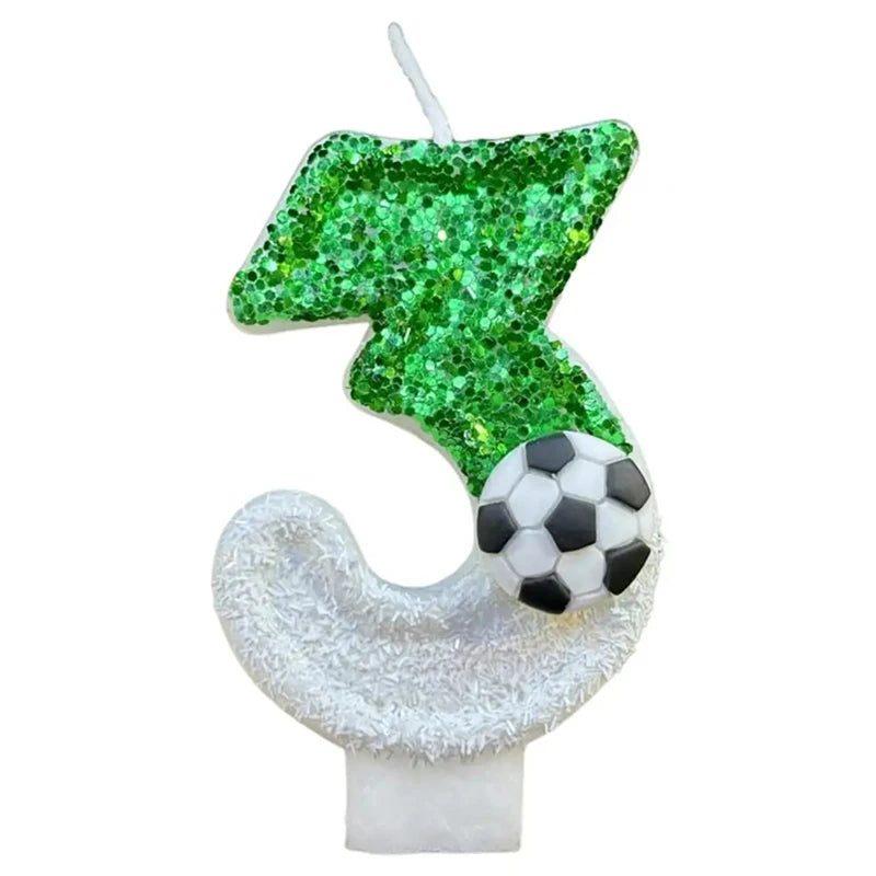 A decorative candle shaped like a soccer ball and a leaf, featuring green glitter and white accents.