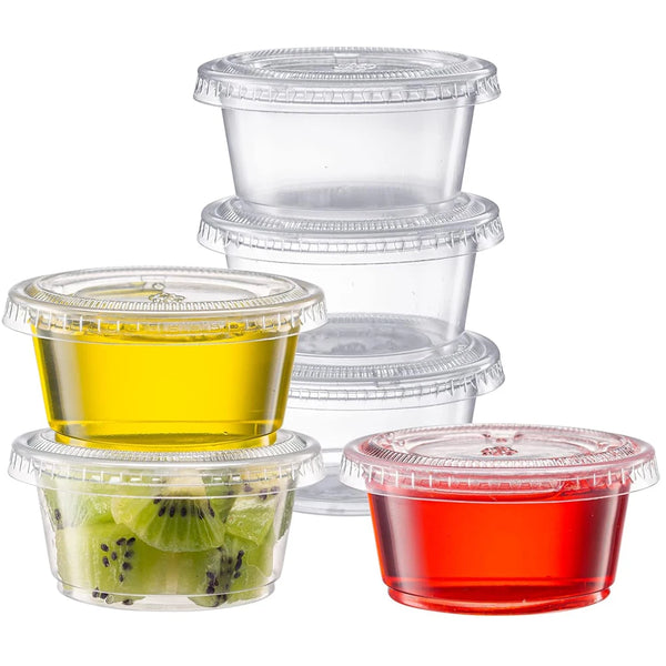A set of clear disposable plastic portion cups with lids, showing samples of yellow, green, and red liquid.