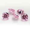 Several loose pink and magenta round cut cubic zirconia stones for jewelry making
