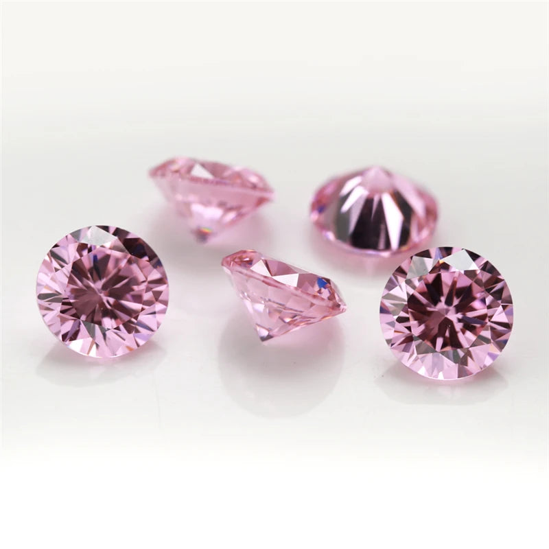 Several loose pink and magenta round cut cubic zirconia stones for jewelry making