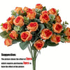 A bouquet of silk orange roses and eucalyptus leaves for wedding or home decor.