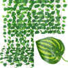 Green artificial ivy vine garland covering a surface and a single green leaf