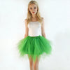 A young woman models a white top and a bright green tulle tutu skirt against a white background.