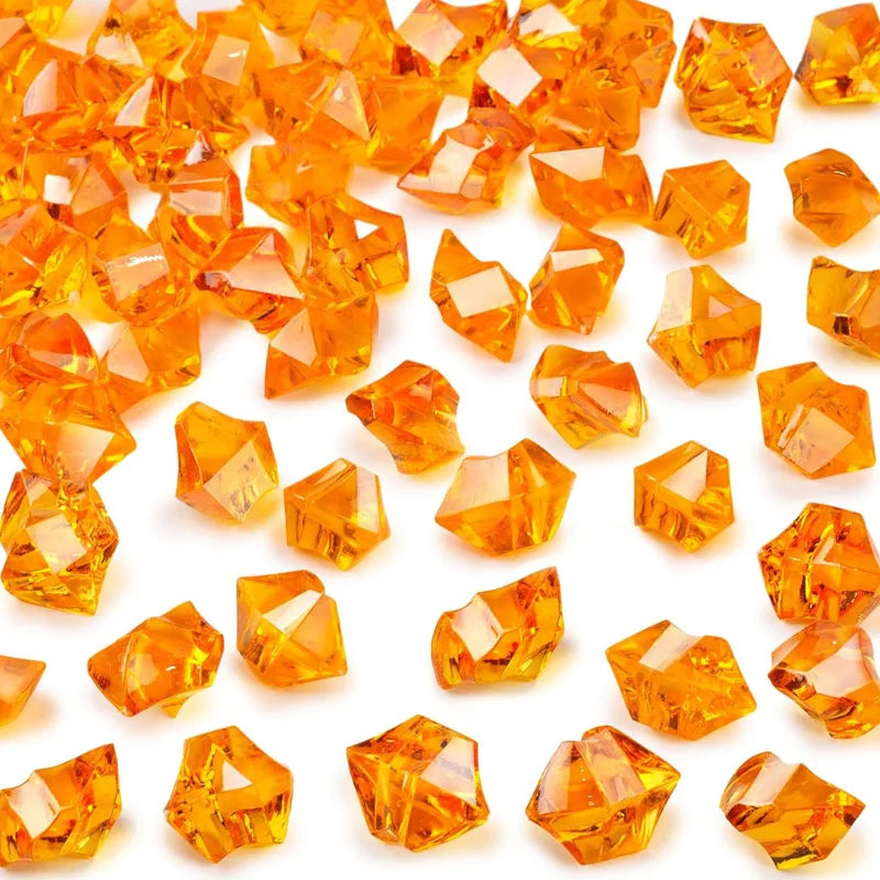 A close-up view of bright orange decorative crushed diamond acrylic pebbles.