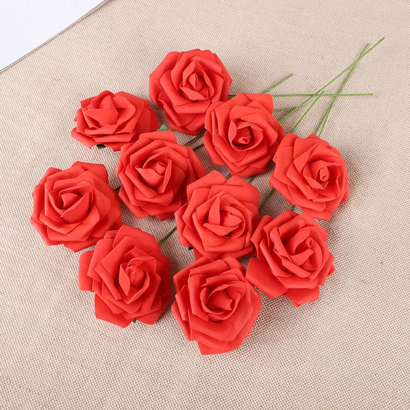 A cluster of twenty vibrant red foam rose blooms arranged on a beige fabric background.