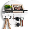 A circular wooden wall key holder with a shelf displaying a framed photo and various keys and watches.