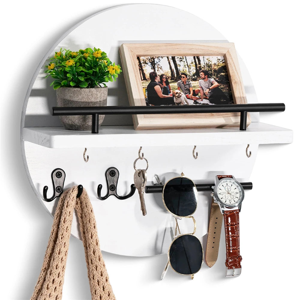 A circular wooden wall key holder with a shelf displaying a framed photo and various keys and watches.
