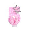 Pink glitter birthday candle shaped like the number 5 with a crown topper