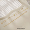Gold ultra-thin layering chain bracelets displayed on a light background with a white wavy fabric.
