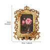 Gold-colored ornate resin photo frame with a pink rose painting inside