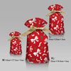 Three festive red drawstring gift bags featuring white snowflake and Santa designs in various sizes