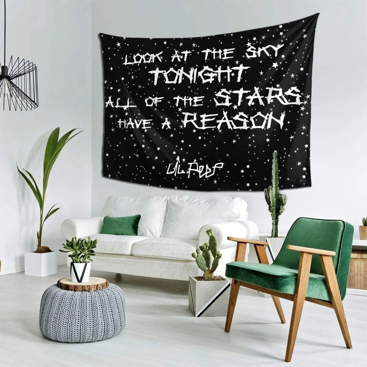 A black tapestry wall hanging featuring white stars and the text Look at the sky tonight all of the stars have a reason.