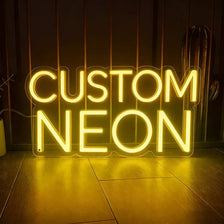 A glowing neon sign spelling out CUSTOM NEON on a dark background.