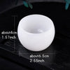 A white crystal agate healing bowl shown on a dark wooden surface with dimension markings.