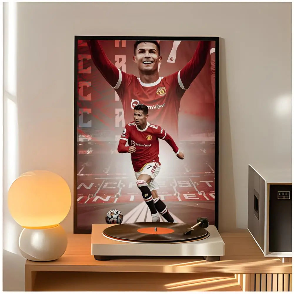 A framed poster of Cristiano Ronaldo celebrating with his arms raised, displayed on a wooden shelf.