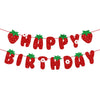 A red glitter banner spelling out HAPPY BIRTHDAY made of strawberries