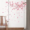 Pink peach blossom branch wall decals featuring delicate pink flowers and petals on a white background.