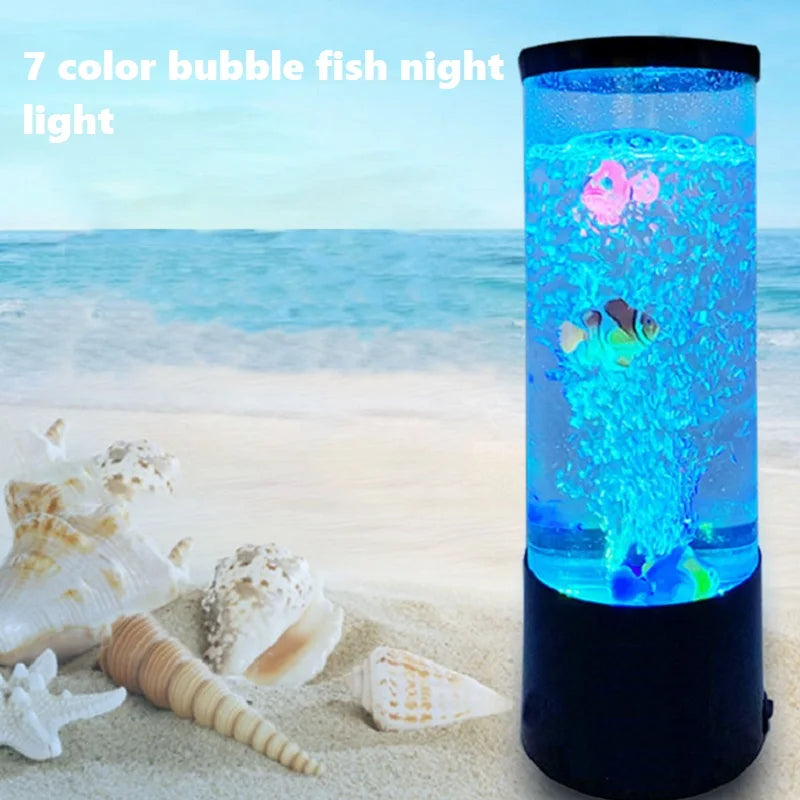 A blue LED fish light illuminates a sandy beach scene with seashells and waves.