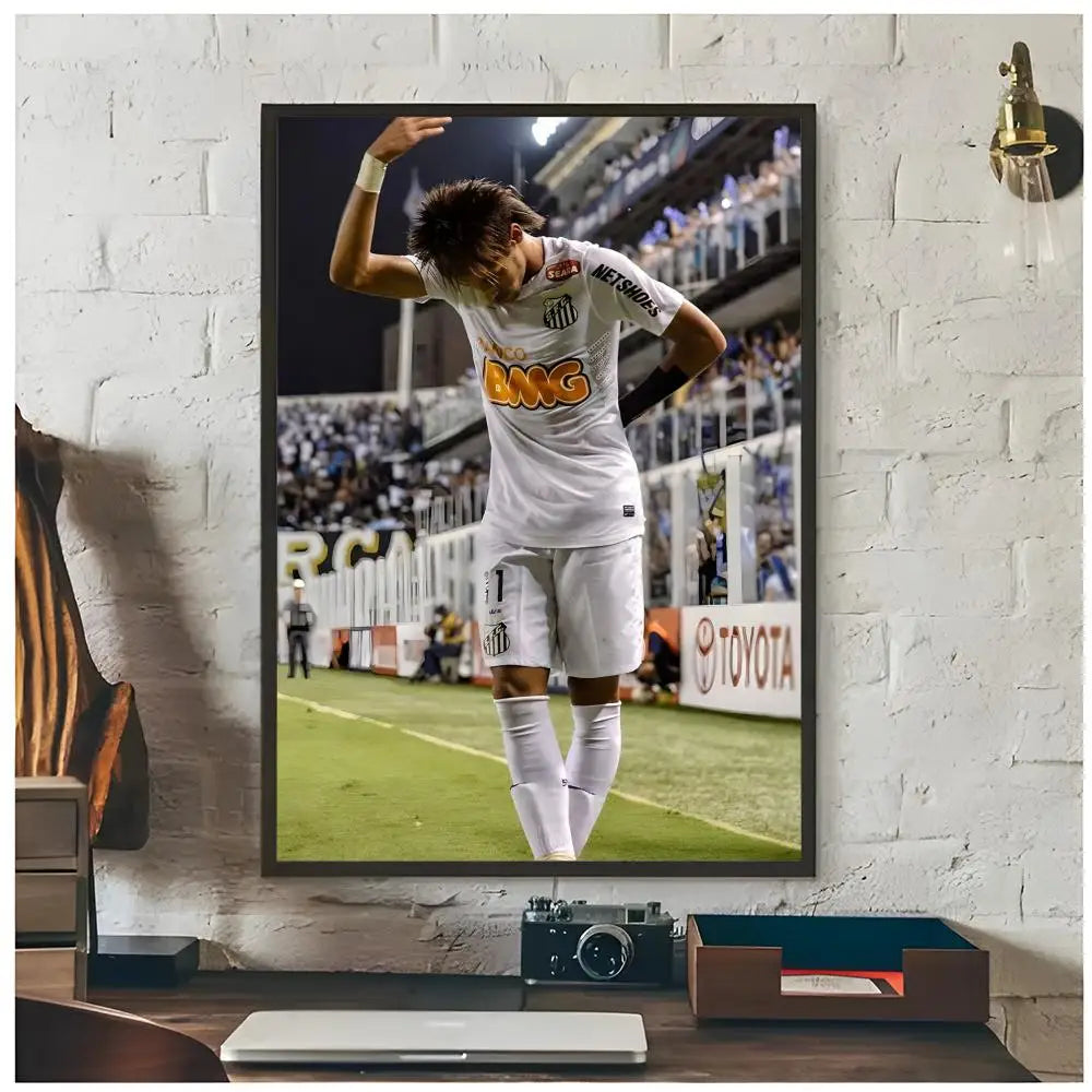 A framed poster of Neymar Jr in a white jersey celebrating on a football field.