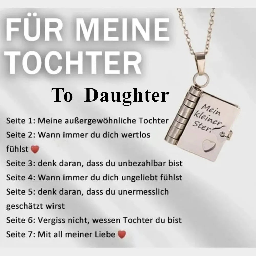 A silver pendant necklace featuring an openable book design with engraved German text for a daughter