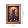 A framed print featuring a silhouette of a black cat against an orange moon and dark trees with small bats and glowing pumpki
