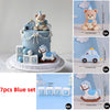 A blue baby blocks set featuring bear and car designs used as cake toppers.