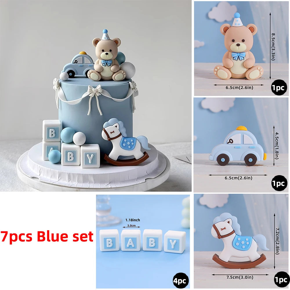 A blue baby blocks set featuring bear and car designs used as cake toppers.