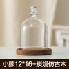 Glass aromatherapy candle holder with a clear dome and wooden base