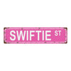 A distressed pink metal tin sign with the text SWIFTIE ST