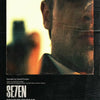 Movie poster for Seven featuring a close-up of a man's face against a bright background.