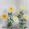 A bouquet of yellow silk poppy flower heads, stems, and bases displayed on a green stand.