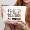 A beige canvas makeup bag featuring the text Teach them love them watch them grow and Ms McGahey