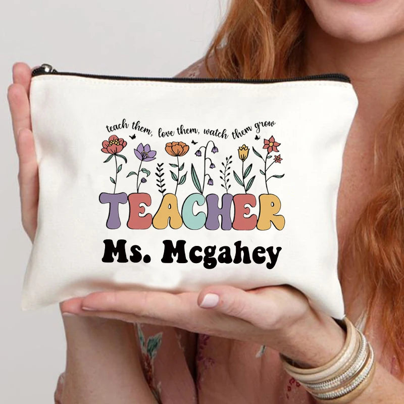 A beige canvas makeup bag featuring the text Teach them love them watch them grow and Ms McGahey